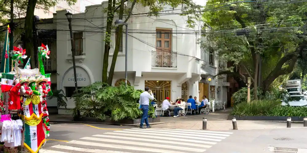 A churrero on a leafy street in the Condesa neighborhood - Mark Craft