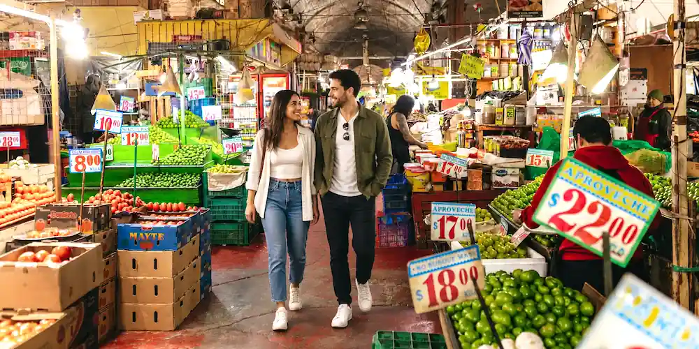Visitors walk through the produce aisles of La Merced Market in Mexico City