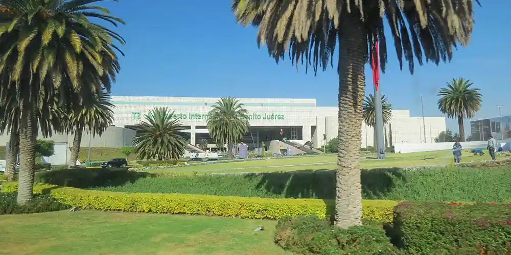 Terminal 2 exterior at Mexico City International Airport with palm trees
