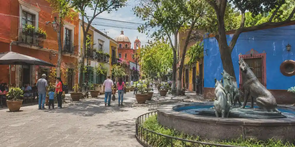 Coyoacán sits south of Centro, organized around plazas, markets, and slower residential streets