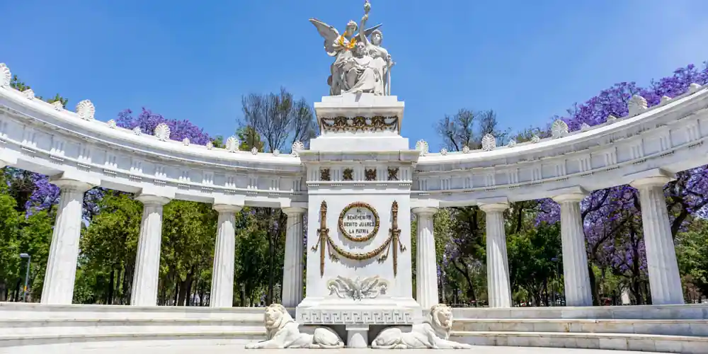 Hemiciclo a Juárez surrounded by blooming jacaranda trees in Mexico City