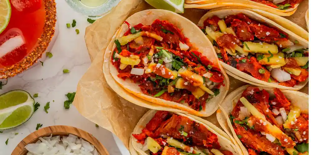 Al pastor tacos with pineapple served at a Mexico City taquería