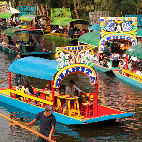 Colorful trajineras on the canals of Xochimilco in Mexico City